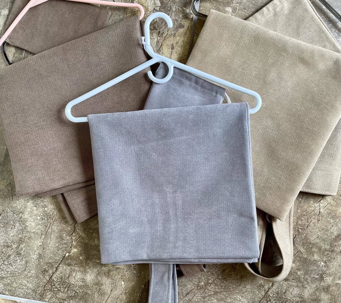 medium brown tote on left, light grey in middle, tan on right